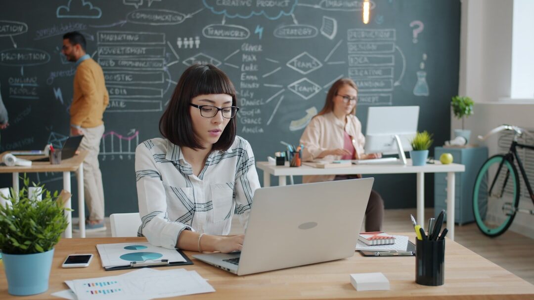 Modern startup office with young team working on computers